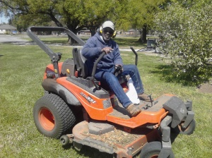 Thomas the groundskeeper on his riding lawnmower.